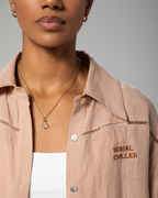 Detail shot of nude linen fabric texture and button detailing from Omni The Label’s signature two-piece set UAE KSA Qatar