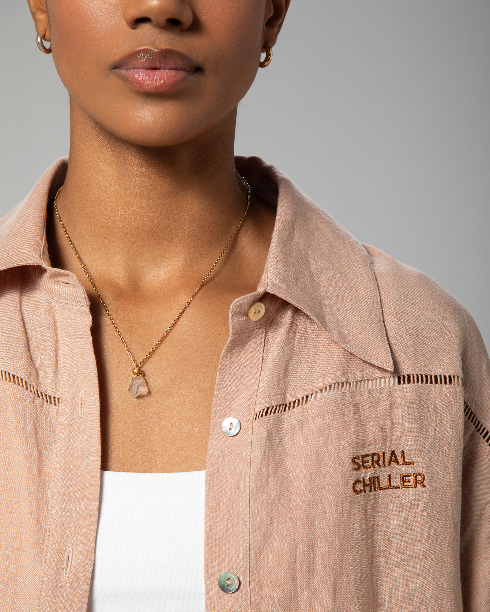 Detail shot of nude linen fabric texture and button detailing from Omni The Label’s signature two-piece set UAE KSA Qatar