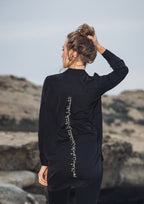  Gold-thread Arabic embroidery on the back of Omni The Label’s black shirt – UAE, KSA, Qatar
