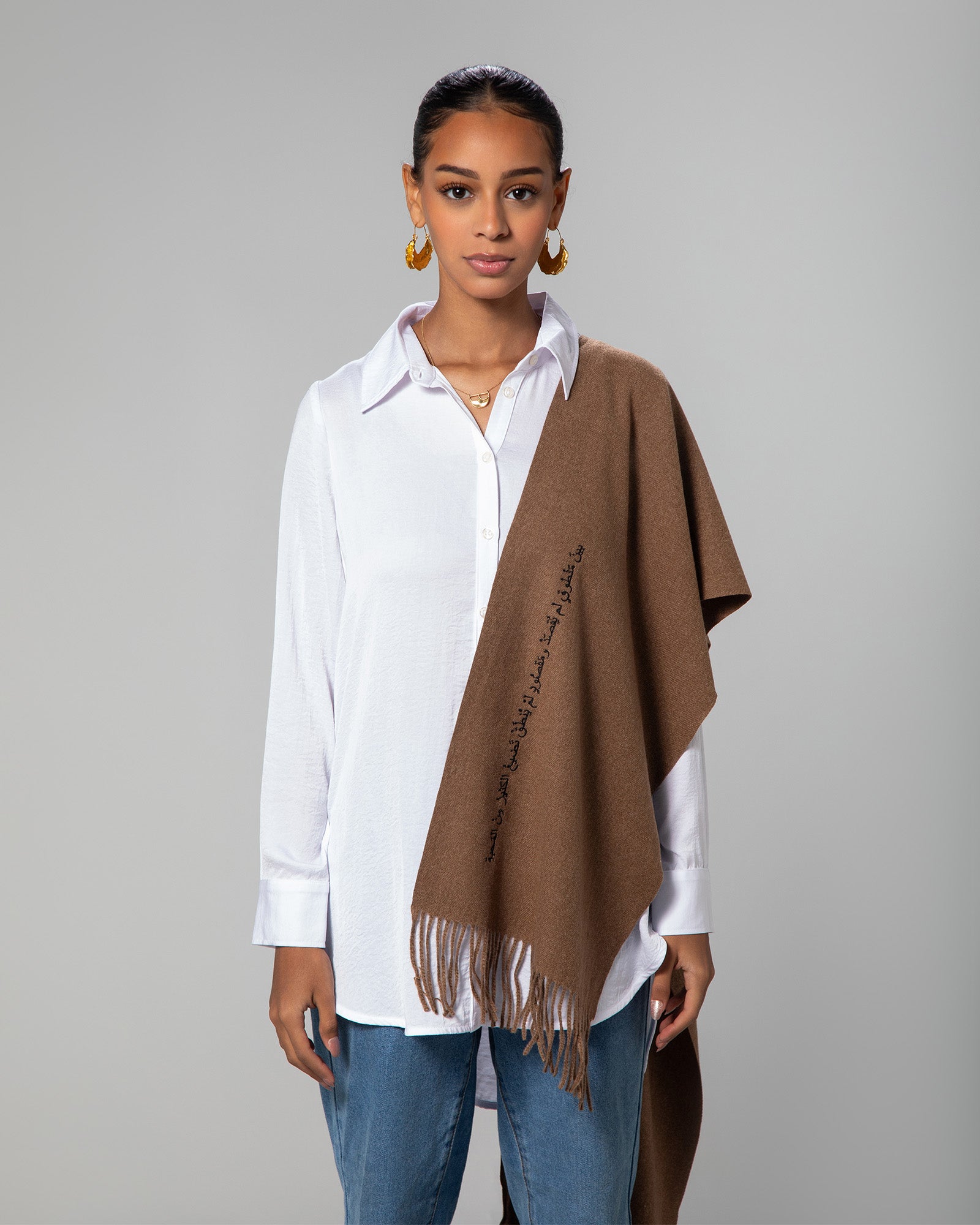 Model wearing brown cashmere-feel scarf over a white shirt, styled casually – UAE, KSA, Qatar