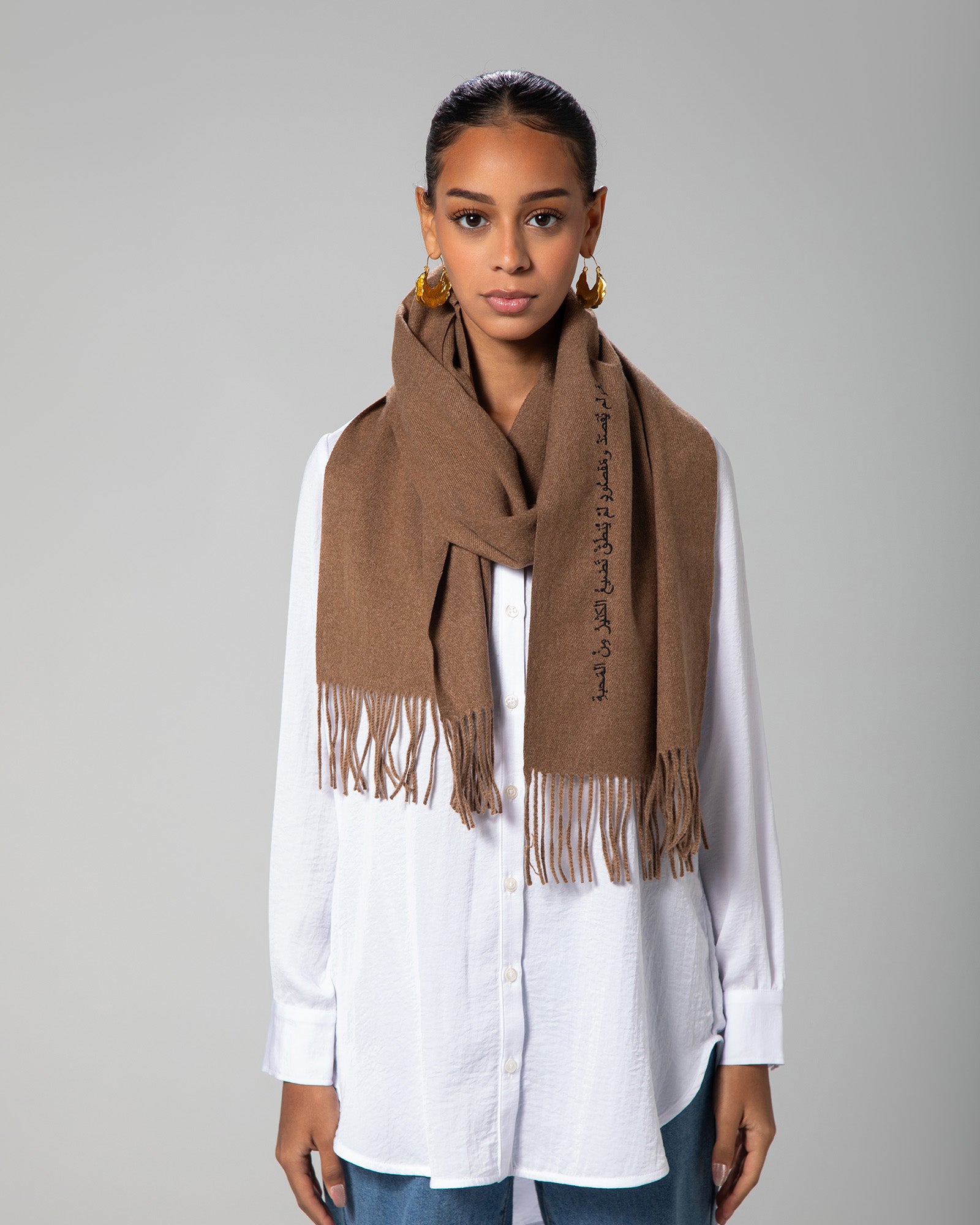 Cashmere-look scarf worn long-line over white shirt and denim, showcasing elegant drape – UAE, KSA, Qatar