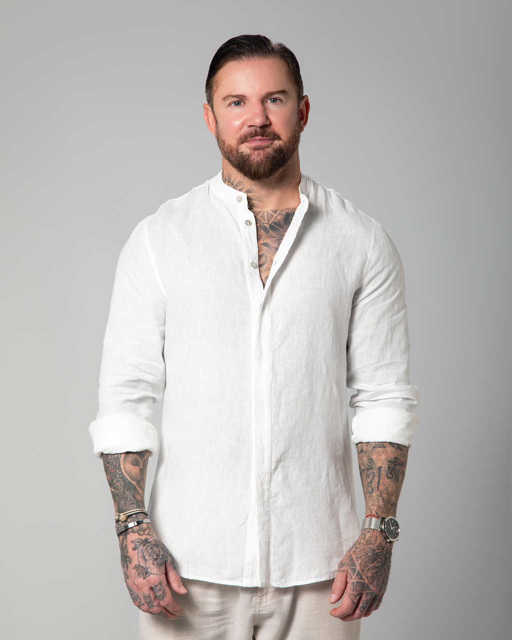 Model styling the white linen shirt open over white tank top by Omni The Label – UAE, KSA, Qatar