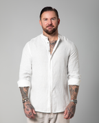 Model styling the white linen shirt open over white tank top by Omni The Label – UAE, KSA, Qatar