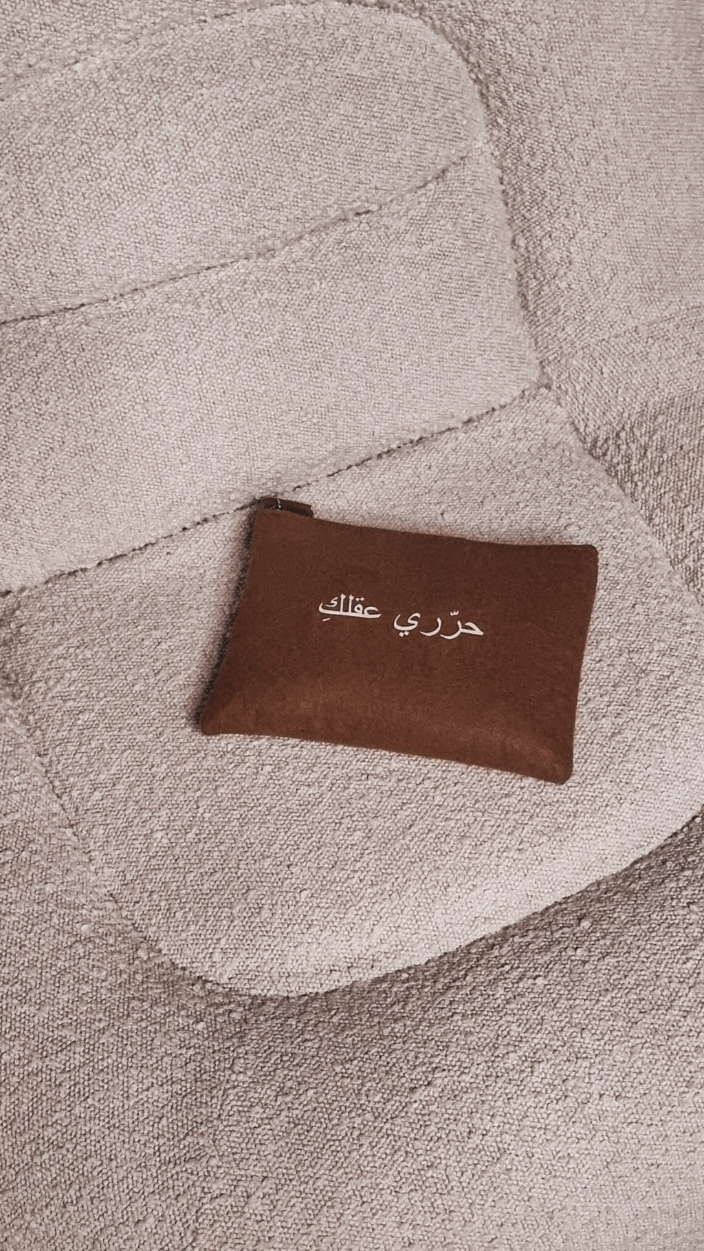 minimalist bag with quote free your mind on a white minimalistic couch UAE, KSA, Qatar