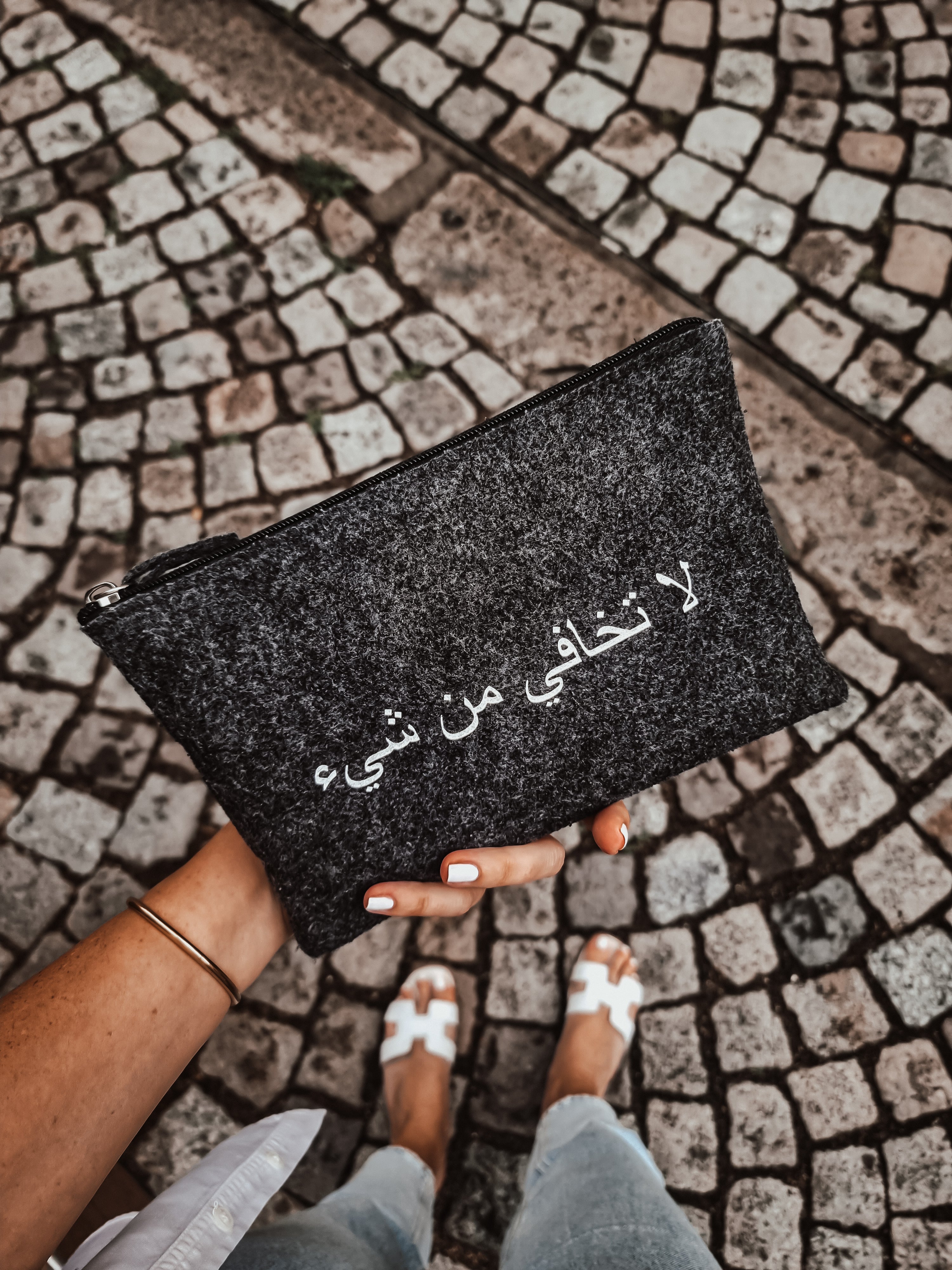women holds grey pouch UAE KSA Qatar